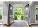Grand entrance with double doors opening to a beautifully landscaped front yard and pathway at 206 Kingsley Way, Woodstock, GA 30188