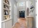 Inviting foyer with hardwood floors, built-in shelves, arched doorways, and a view of the double front doors at 206 Kingsley Way, Woodstock, GA 30188