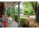 Inviting covered front porch with rocking chairs, providing a relaxing outdoor space with views of the landscaped yard at 206 Kingsley Way, Woodstock, GA 30188