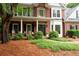 Beautifully landscaped front yard with brick facade and inviting front porch seating at 206 Kingsley Way, Woodstock, GA 30188