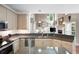 Modern kitchen showcases stainless steel appliances, granite countertops, and an open design at 206 Kingsley Way, Woodstock, GA 30188