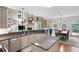Open concept kitchen with granite counters, stainless steel appliances, and views of the dining area at 206 Kingsley Way, Woodstock, GA 30188