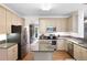 Bright kitchen with stainless appliances, granite countertops, center island, and view to the backyard at 206 Kingsley Way, Woodstock, GA 30188