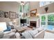 Spacious living room with tall windows overlooking a pool, fireplace, and neutral color scheme at 206 Kingsley Way, Woodstock, GA 30188