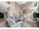 Bright living room with a staircase, lots of natural light, neutral color scheme, and hardwood floors at 206 Kingsley Way, Woodstock, GA 30188