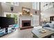 Cozy living room featuring a fireplace, neutral decor, and large windows overlooking the pool at 206 Kingsley Way, Woodstock, GA 30188