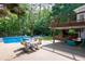 Backyard patio with dining area and lounge seating next to the pool at 206 Kingsley Way, Woodstock, GA 30188
