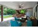 Covered outdoor patio with stylish furniture and lush landscaping at 206 Kingsley Way, Woodstock, GA 30188