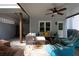 Covered patio with a ceiling fan with comfortable seating and outdoor decor at 206 Kingsley Way, Woodstock, GA 30188
