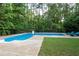 Backyard pool featuring a volleyball net, with lounge chairs and green space at 206 Kingsley Way, Woodstock, GA 30188