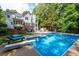 Backyard pool with diving board surrounded by lush trees at 206 Kingsley Way, Woodstock, GA 30188