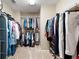 Ample walk-in closet providing storage space with built in shelves and racks for clothes and shoes at 206 Kingsley Way, Woodstock, GA 30188