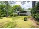 Expansive backyard featuring a screened-in porch, a deck, and lush green grass and mature trees at 2519 Lauderdale Ne Dr, Atlanta, GA 30345