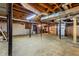 Unfinished basement with exposed ceiling, concrete floors, and support beams at 2519 Lauderdale Ne Dr, Atlanta, GA 30345
