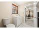 Bathroom with a window, white vanity, toilet, and neutral walls with a view to the living area at 2519 Lauderdale Ne Dr, Atlanta, GA 30345