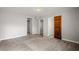 Spacious bedroom features neutral gray walls, carpet, and doors to closets at 2519 Lauderdale Ne Dr, Atlanta, GA 30345