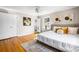 Comfortable bedroom with hardwood floors, a window, art, and a cozy bed with decorative pillows at 2519 Lauderdale Ne Dr, Atlanta, GA 30345