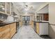 Kitchen boasts light wood cabinets, black counters, gray backsplash, and stainless steel appliances at 2519 Lauderdale Ne Dr, Atlanta, GA 30345