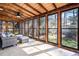 Bright sunroom with wood ceiling and multiple windows providing natural light and views of the outdoor landscape at 2519 Lauderdale Ne Dr, Atlanta, GA 30345