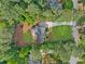 An aerial view shows this home's secluded location and manicured lawn in a wooded community near other homes at 2885 Laurel Green Ct, Roswell, GA 30076