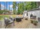 Backyard with outdoor dining, lounge chairs, and manicured lawn at 2885 Laurel Green Ct, Roswell, GA 30076