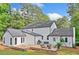 Expansive backyard with wooden deck, patio seating, and mature trees at 2885 Laurel Green Ct, Roswell, GA 30076