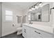 Bright and modern bathroom with a large mirror, sleek vanity, gray floors, and shower with glass door at 2885 Laurel Green Ct, Roswell, GA 30076