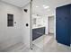 Luxurious bathroom featuring a large shower, dual vanity with blue cabinets, and a view of the toilet at 2885 Laurel Green Ct, Roswell, GA 30076
