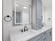 An elegant bathroom featuring sleek, dual sinks, black fixtures, and a bright, modern design aesthetic at 2885 Laurel Green Ct, Roswell, GA 30076