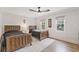 Bright bedroom with two beds, hardwood floors, neutral walls, ceiling fan, and natural light at 2885 Laurel Green Ct, Roswell, GA 30076