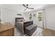 Cozy bedroom with a bed, bedside table, dresser, neutral walls, hardwood floors, and natural light at 2885 Laurel Green Ct, Roswell, GA 30076