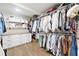 Spacious closet with custom shelves, hanging rods, drawers, hardwood floors, and ample storage space at 2885 Laurel Green Ct, Roswell, GA 30076