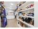 Organized walk-in closet featuring custom shelving for shoes and clothes, and hardwood flooring at 2885 Laurel Green Ct, Roswell, GA 30076