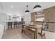 Stylish dining area with wooden table, modern lighting, and convenient kitchen access at 2885 Laurel Green Ct, Roswell, GA 30076