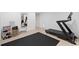 Basement exercise room with workout equipment, mirror, and plank walls at 2885 Laurel Green Ct, Roswell, GA 30076