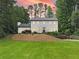 Charming white two-story home with manicured landscaping and beautiful curb appeal at 2885 Laurel Green Ct, Roswell, GA 30076