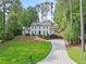 Charming two-story traditional home with a long driveway, lush landscaping, and a well manicured lawn at 2885 Laurel Green Ct, Roswell, GA 30076