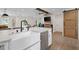 Modern kitchen features a farmhouse sink, stainless steel appliances, and an open design at 2885 Laurel Green Ct, Roswell, GA 30076