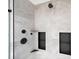 A modern and stylish shower featuring sleek black fixtures, grey tile, and built in shelving at 2885 Laurel Green Ct, Roswell, GA 30076