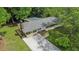 Aerial view of the home with a long driveway, a backyard fire pit, and a carport at 3852 Drew Campground Rd, Cumming, GA 30040