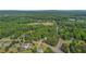 An aerial shot offers a comprehensive view of the home and its leafy surroundings at 3852 Drew Campground Rd, Cumming, GA 30040