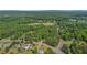 Aerial shot featuring a home surrounded by trees and a tranquil neighborhood setting at 3852 Drew Campground Rd, Cumming, GA 30040