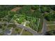 Aerial view outlining property with lush trees and landscaping on a secluded lot at 3852 Drew Campground Rd, Cumming, GA 30040