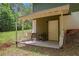 Covered back porch featuring an entry door with seating, leading to outdoor spaces at 3852 Drew Campground Rd, Cumming, GA 30040