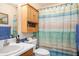 Well-lit bathroom with a toilet, sink, mirror, and a shower with curtain at 3852 Drew Campground Rd, Cumming, GA 30040