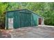 Large detached metal garage featuring roll up door and additional doorway on property at 3852 Drew Campground Rd, Cumming, GA 30040