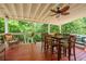 Spacious covered porch with wooded views, perfect for relaxing or entertaining outdoors at 3852 Drew Campground Rd, Cumming, GA 30040