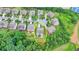Aerial view of a two story home with a deck and walk-out basement located in a suburban neighborhood at 5770 Bridleton Xing, Suwanee, GA 30024