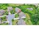 Aerial perspective of a home in a cul-de-sac, highlighting its proximity to green space and roads at 5770 Bridleton Xing, Suwanee, GA 30024