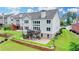 Aerial shot of the back of the house featuring a nice back yard, a deck, and a walkout basement at 5770 Bridleton Xing, Suwanee, GA 30024